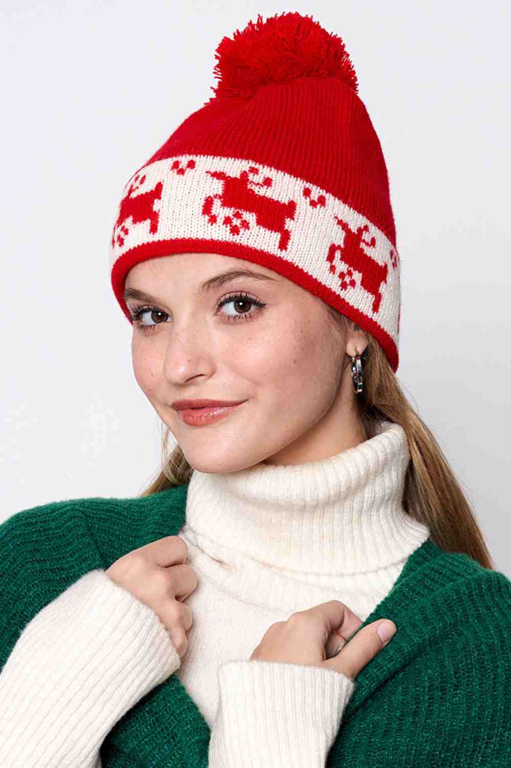 Red Reindeer Christmas Holiday Pom Beanie features festive reindeer detailing topped with a fluffy pom for a cheerful, winter-ready holiday look. Designed with a soft stretch fit, it keeps you warm and cozy while adding playful seasonal charm to your cold-weather outfits.