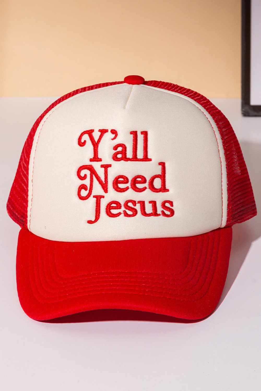Red Y'ALL NEED JESUS Letter Foam with Mesh Back Trucker Hat Baseball Cap Make a bold statement with this classic trucker cap featuring embroidered lettering across the front. Crafted from 100% polyester with a breathable mesh back panel, it's designed for all-day comfort and ventilation. The structured foam front provides durability and shape retention, while the adjustable snapback closure ensures a perfect fit for most head sizes. Whether you're heading to the gym, running errands, or making a fashion sta