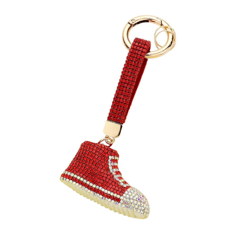 Red Rhinestone Pave Sneaker Bag Charm features a sparkling rhinestone pave design that is sure to add a touch of glamour to any bag. The charm is perfect for sneaker lovers and fashionistas alike, making it a versatile and stylish accessory. With its high-quality construction, this charm is a must-have for any fashion-forward individual.