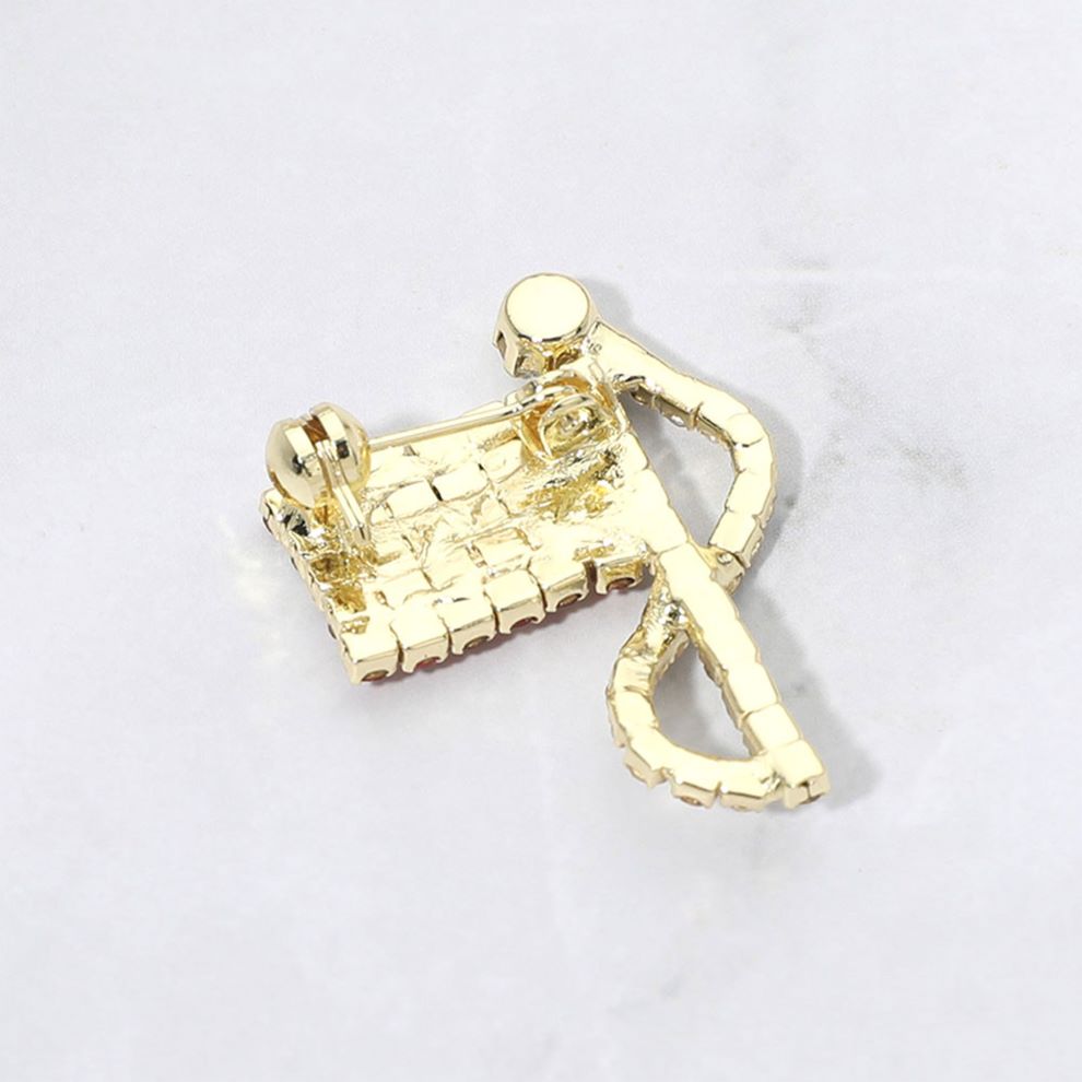 Gold Statement flag inspired brooch designed with a flowing ribbon silhouette and shimmering rhinestone accents. A bold decorative accessory ideal for jackets, coats, scarves, hats, bags, and event outfits. Perfect for patriotic celebrations, themed events, gifting, or adding eye catching detail to everyday styling.