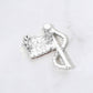 Silver Silver Statement flag inspired brooch designed with a flowing ribbon silhouette and shimmering rhinestone accents. A bold decorative accessory ideal for jackets, coats, scarves, hats, bags, and event outfits. Perfect for patriotic celebrations, themed events, gifting, or adding eye catching detail to everyday styling.