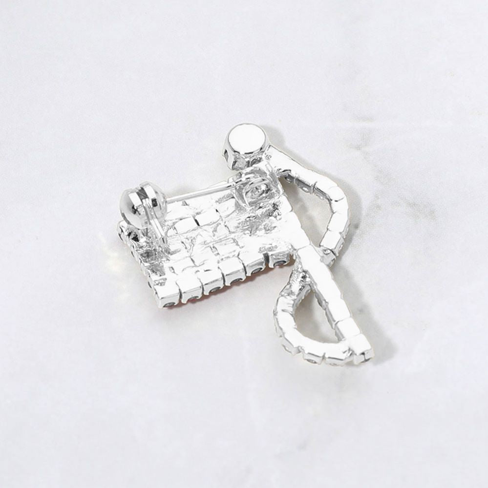 Silver Silver Statement flag inspired brooch designed with a flowing ribbon silhouette and shimmering rhinestone accents. A bold decorative accessory ideal for jackets, coats, scarves, hats, bags, and event outfits. Perfect for patriotic celebrations, themed events, gifting, or adding eye catching detail to everyday styling.