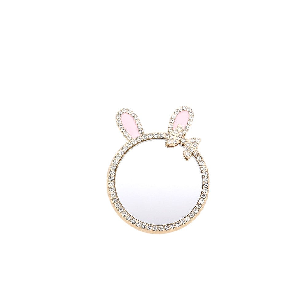 Gold Rhinestone Bunny Bow Mirror Adhesive Phone Grip and Stand is the perfect accessory for your phone. The rhinestone embellishments add a touch of glamour, while the mirror feature is convenient for on-the-go touch-ups. The adhesive backing provides a secure grip, making it a versatile and functional accessory. 