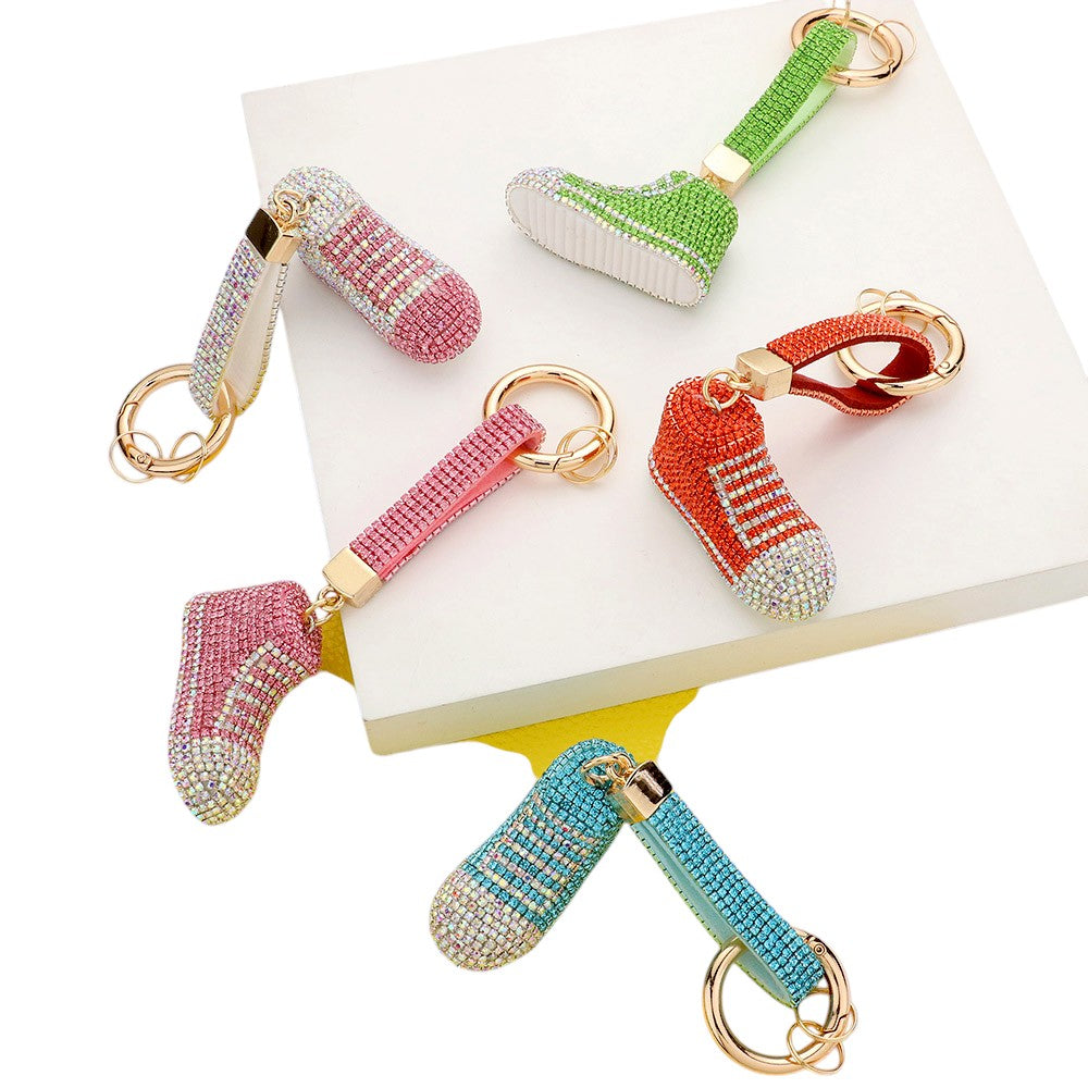 AB Rhinestone Pave Sneaker Bag Charm features a sparkling rhinestone pave design that is sure to add a touch of glamour to any bag. The charm is perfect for sneaker lovers and fashionistas alike, making it a versatile and stylish accessory. With its high-quality construction, this charm is a must-have for any fashion-forward individual.