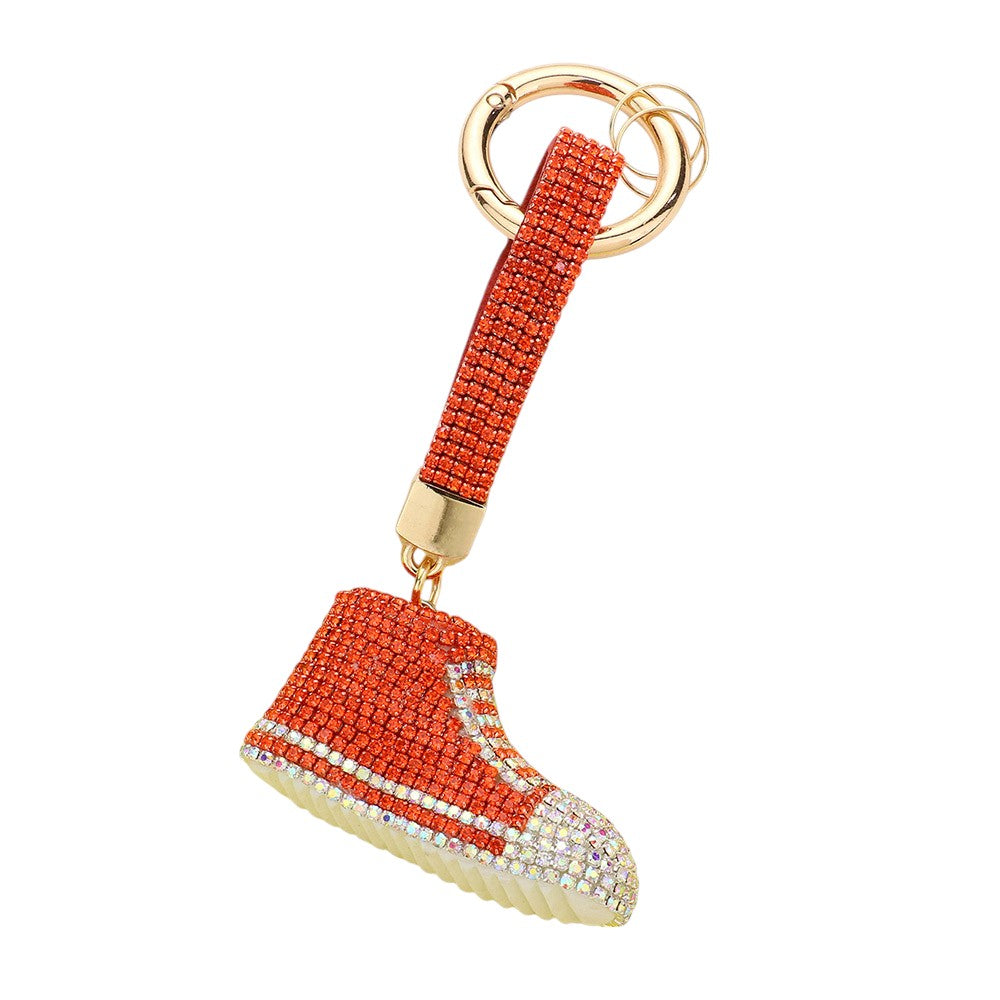 Orange Rhinestone Pave Sneaker Bag Charm features a sparkling rhinestone pave design that is sure to add a touch of glamour to any bag. The charm is perfect for sneaker lovers and fashionistas alike, making it a versatile and stylish accessory. With its high-quality construction, this charm is a must-have for any fashion-forward individual.