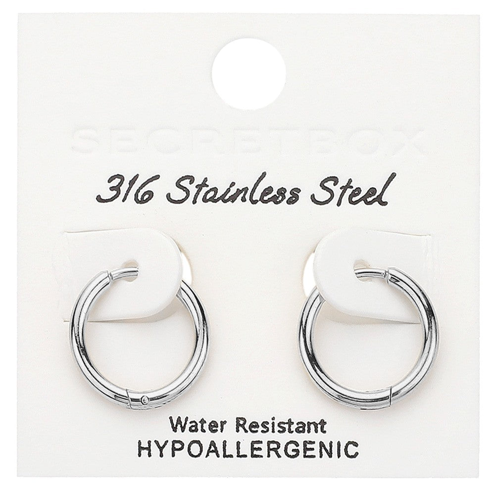Rhodium SECRET BOX Stainless Steel Huggie Hoop Earrings offer a sleek and durable design. Made from high-quality stainless steel, they are hypoallergenic and perfect for everyday wear. Their huggie hoop style ensures a secure fit, making them the ideal accessory for any occasion.