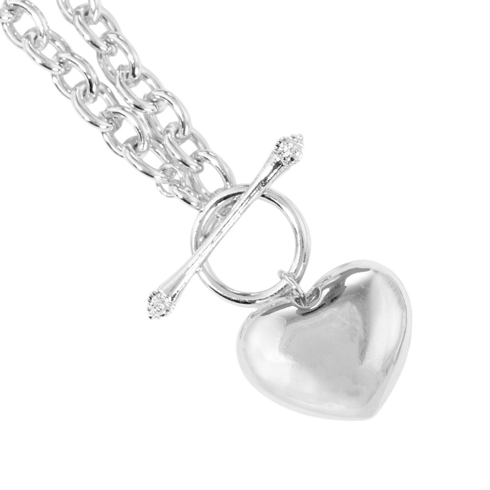 Rhodium White Gold Dipped Brass Metal Heart Pendant Toggle Necklace is a beautiful addition to any jewelry collection. Made from white gold dipped brass, the heart pendant and toggle closure add a touch of elegance to any outfit. With its durable construction and timeless design, this necklace is perfect for any occasion.