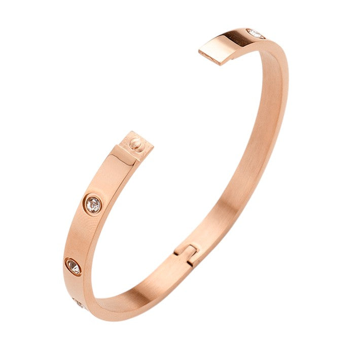 Gold Rose Stainless Steel Crystal Embellished Bangle Evening Bracelet is a must-have accessory for any evening event. Made with durable stainless steel and adorned with dazzling crystals, this bracelet adds a touch of elegance and sophistication. Perfect for a formal dinner or a night out on the town.
