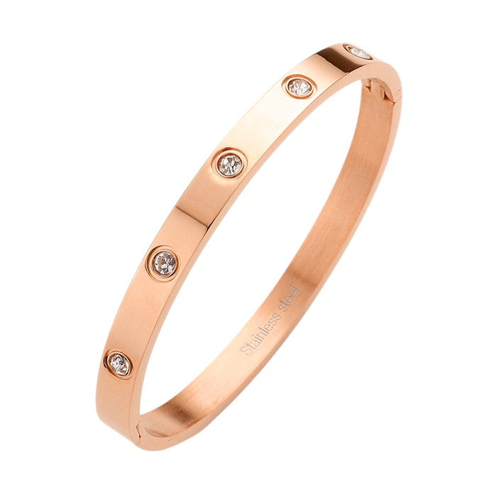 Gold Rose Stainless Steel Crystal Embellished Bangle Evening Bracelet is a must-have accessory for any evening event. Made with durable stainless steel and adorned with dazzling crystals, this bracelet adds a touch of elegance and sophistication. Perfect for a formal dinner or a night out on the town.