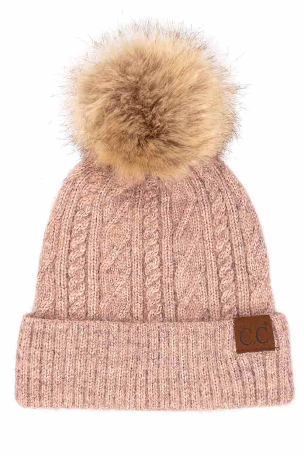 Rose The C.C Soft Cuff Beanie in Mixed Cable Pattern with Faux Fur Pom features a stylish blend of cable-knit textures topped with a plush faux fur pom for a chic winter look. Made from soft, stretchy fabric with a cozy cuff, it provides warmth, comfort, and a snug fit for cold-weather wear.