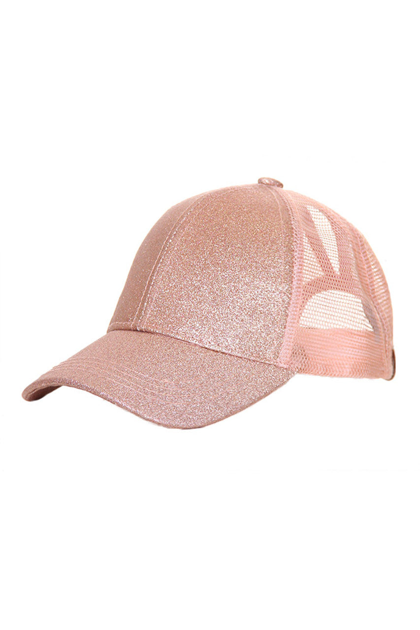 RoseGold C.C Baseball Ponycap combines classic baseball cap style with a convenient ponytail opening, offering both comfort and functionality. Crafted from breathable materials, it ensures all-day wearability while accommodating various hair types and styles. Ideal for active lifestyles, this cap provides sun protection without compromising on style or practicality. 