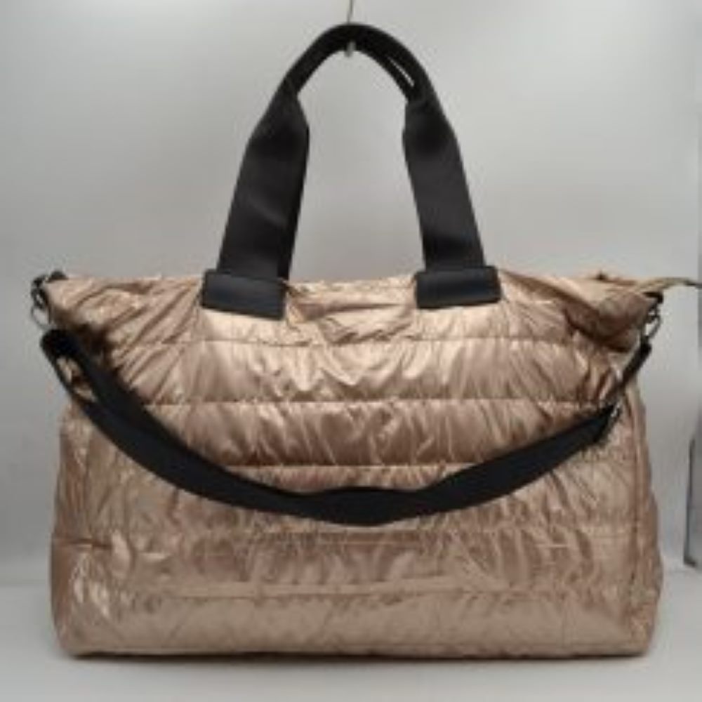 Rose Upgrade your travel gear with this exceptionally spacious, lightweight weekender duffel bag, perfect for overnight trips, gym sessions, or casual weekend getaways. Featuring a stylish horizontally quilted puffer design, this bag combines a cozy, modern aesthetic with highly practical function. It is designed with wide, durable webbed top handles for a comfortable grip, alongside a matching adjustable and detachable shoulder strap secured by polished metallic clasps for easy hands-free carrying.