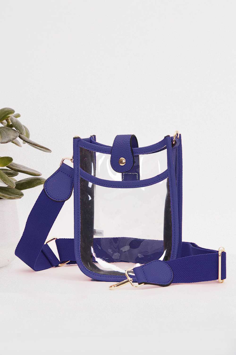 Royal Blue Perfect for concert season and stadium events, this clear crossbody mini bag meets all venue security requirements while keeping your essentials within reach. Crafted from durable 100% PVC, it's easy to clean and built to last through countless outings. Compact yet functional at 8" x 5.8" x 2.3", the adjustable crossbody strap sits comfortably across your body, leaving your hands free. The transparent design lets you quickly locate your phone, keys, and small valuables at a glance.