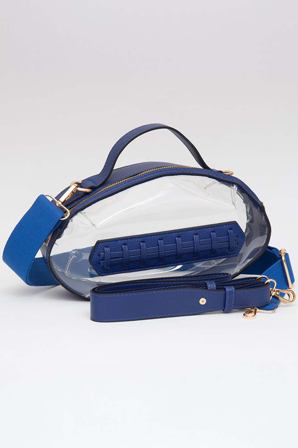 Royal Blue Carry your essentials in style with this unique football-shaped transparent crossbody bag. Perfect for stadium events, concerts, and outdoor gatherings, the clear PVC design lets you see everything inside while meeting venue security requirements. Measuring 11" x 6" x 4", it offers practical storage without bulk. The adjustable crossbody strap keeps your hands free, making it ideal for busy days out. Durable 100% PVC construction ensures long-lasting wear through countless adventures.