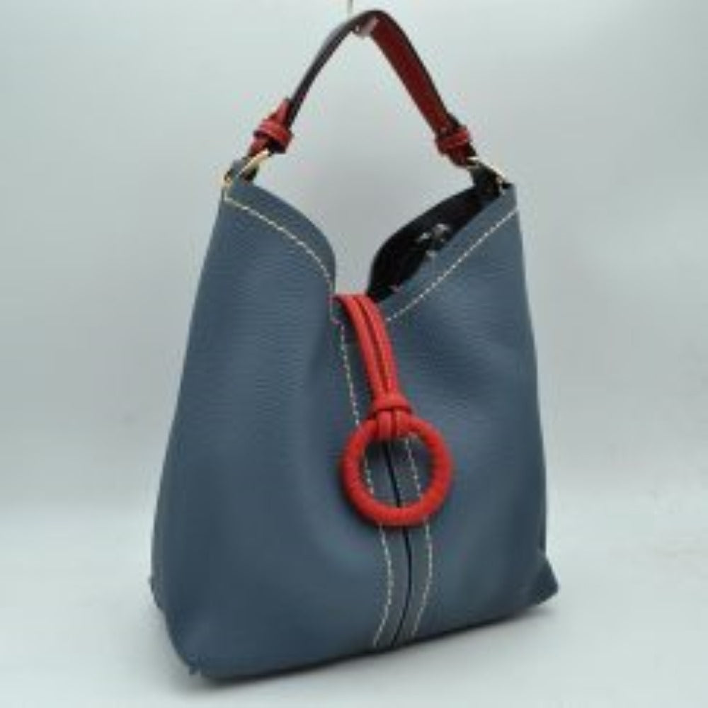 Royal blue This structured everyday bucket bag features a pebbled textured body with a distinctive curved, dip-top opening and prominent contrast stitching details along the front panel. It is designed with a singular flat top handle anchored to the sides by polished metal hardware loops for comfortable carrying. A central loop strap extends from the back to the front