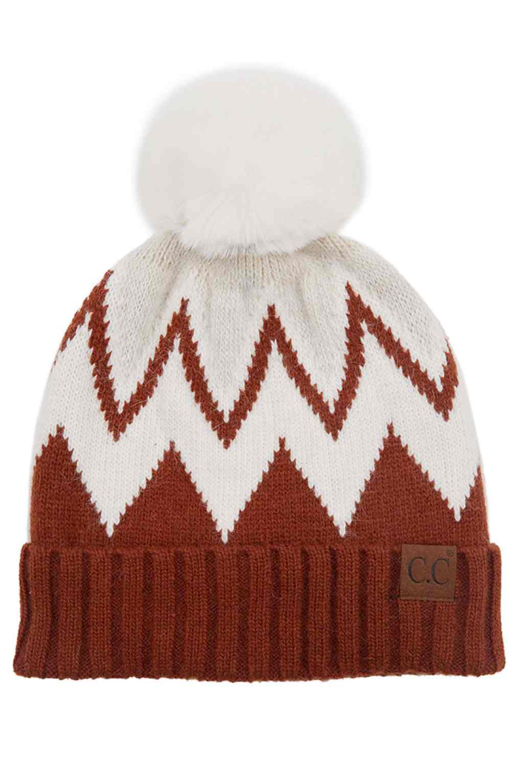 Rust Stay warm and stylish with this chevron knit beanie crafted from a premium blend of 70% acrylic and 30% angora. The ribbed construction provides a snug fit, while the fluffy pom pom adds a playful touch. Soft, breathable, and designed to complement any winter look, this versatile beanie is your go-to accessory for cold weather comfort.