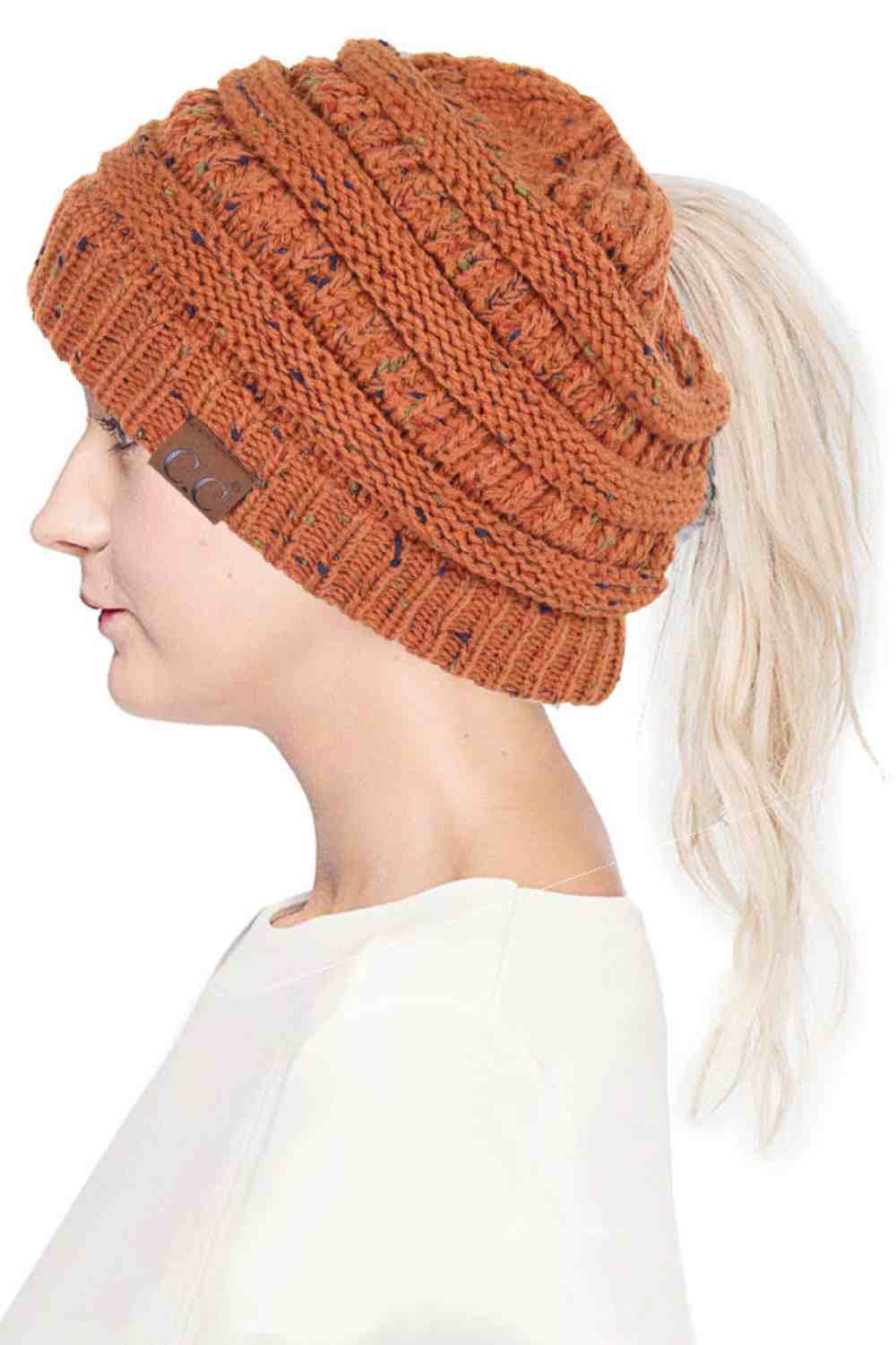 Rust The C.C Confetti Ponytail Messy Bun Beanie features a soft knit design with subtle confetti flecks for a fun, playful look. Designed with a convenient opening for ponytails or messy buns, it keeps you warm while allowing you to style your hair comfortably.