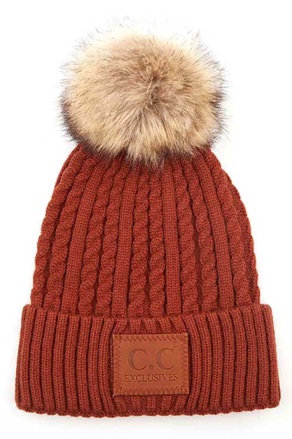 Rust Stay warm and stylish with the C.C Double Braided Beanie, featuring a cozy pom-pom and iconic C.C leather patch. Crafted from a durable blend of 75% acrylic and 25% nylon, this beanie offers comfort and longevity through every season.