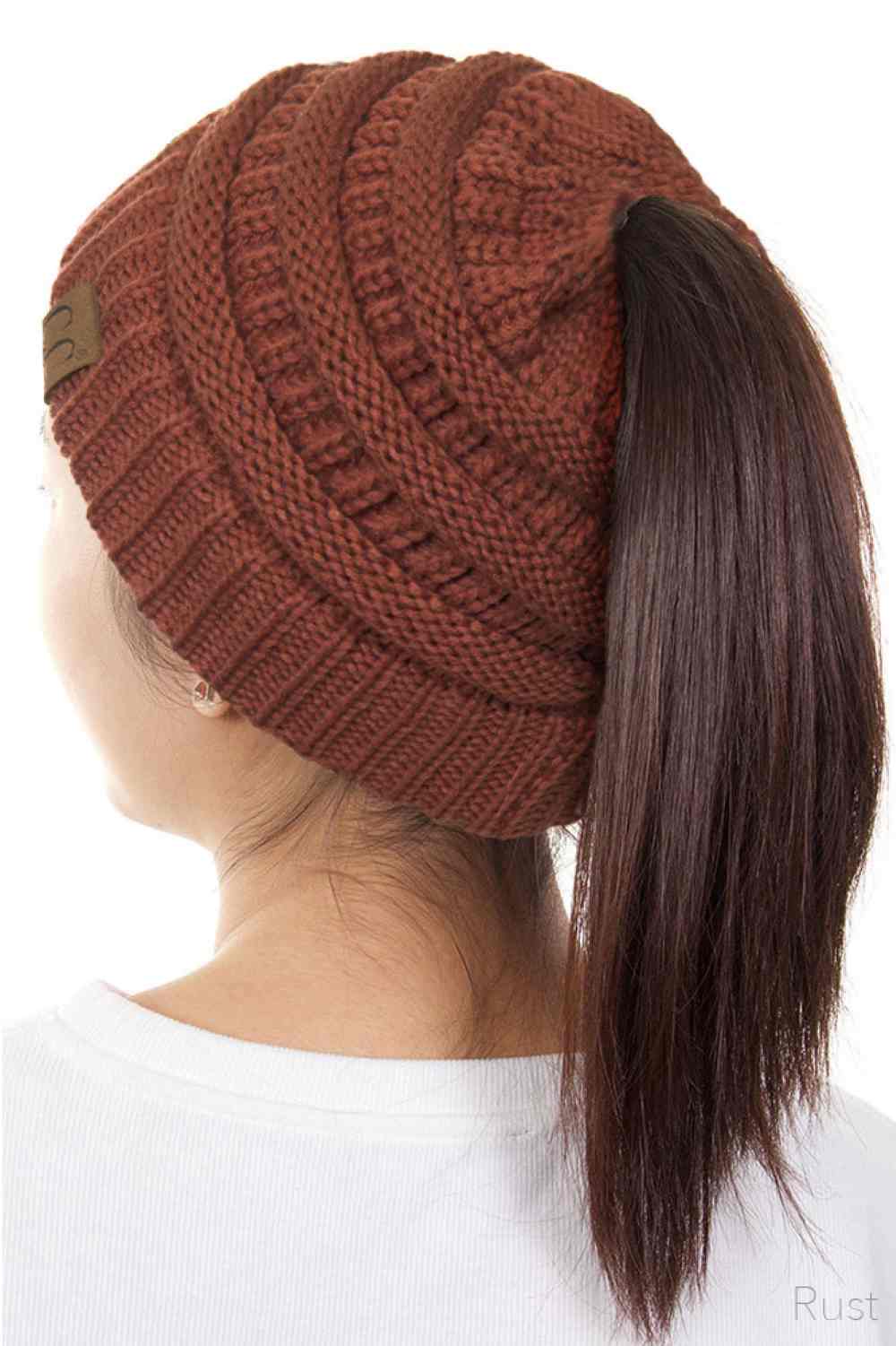 Rust The C.C Solid Color Ponytail Messy Bun Beanie combines comfort with versatility for effortless everyday style. Crafted from 100% soft acrylic, this beanie features an open crown design that accommodates ponytails and messy buns while keeping you warm. The one-size-fits-most construction ensures a secure, flattering fit for virtually anyone. Perfect for casual outings, workouts, or relaxed weekends, this practical accessory transitions seamlessly from season to season.