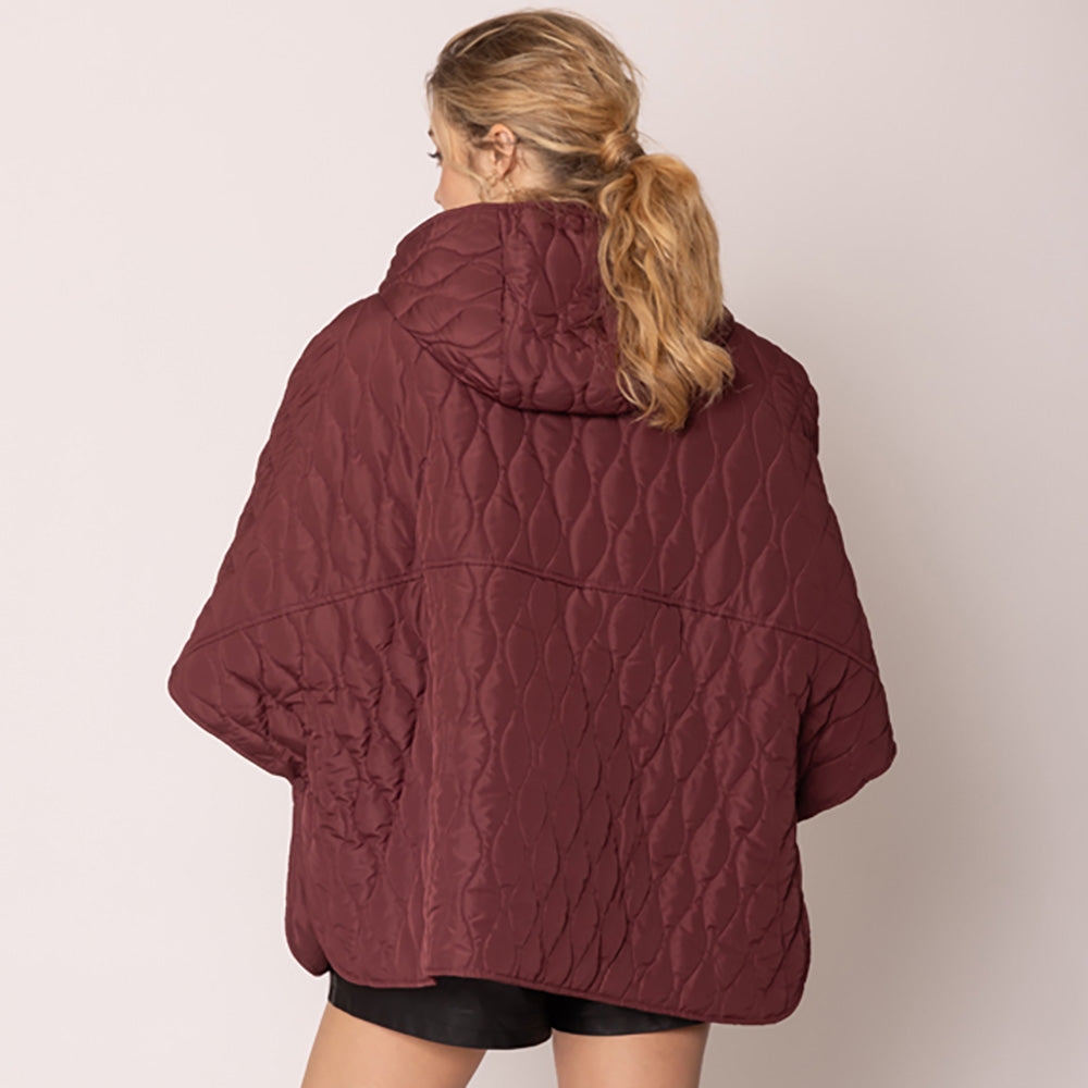 Burgundy Stylish quilted cape jacket featuring a relaxed silhouette, button-up front, and attached hood for added comfort. Perfect for layering during cooler seasons, this versatile outerwear piece combines warmth with a modern, minimalistic design for effortless everyday style.
