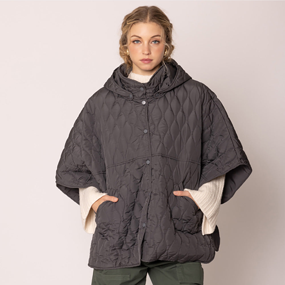 Charcoal Stylish quilted cape jacket featuring a relaxed silhouette, button-up front, and attached hood for added comfort. Perfect for layering during cooler seasons, this versatile outerwear piece combines warmth with a modern, minimalistic design for effortless everyday style.