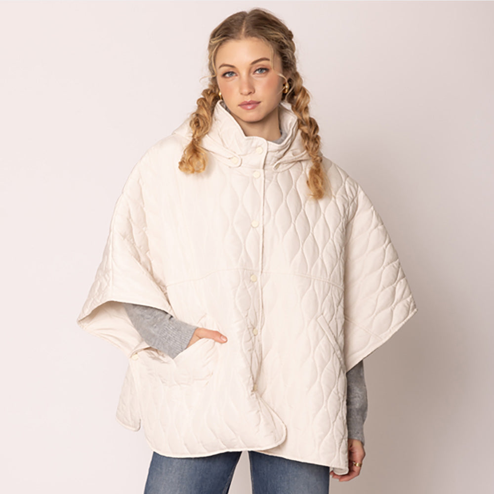 Ivory Stylish quilted cape jacket featuring a relaxed silhouette, button-up front, and attached hood for added comfort. Perfect for layering during cooler seasons, this versatile outerwear piece combines warmth with a modern, minimalistic design for effortless everyday style.