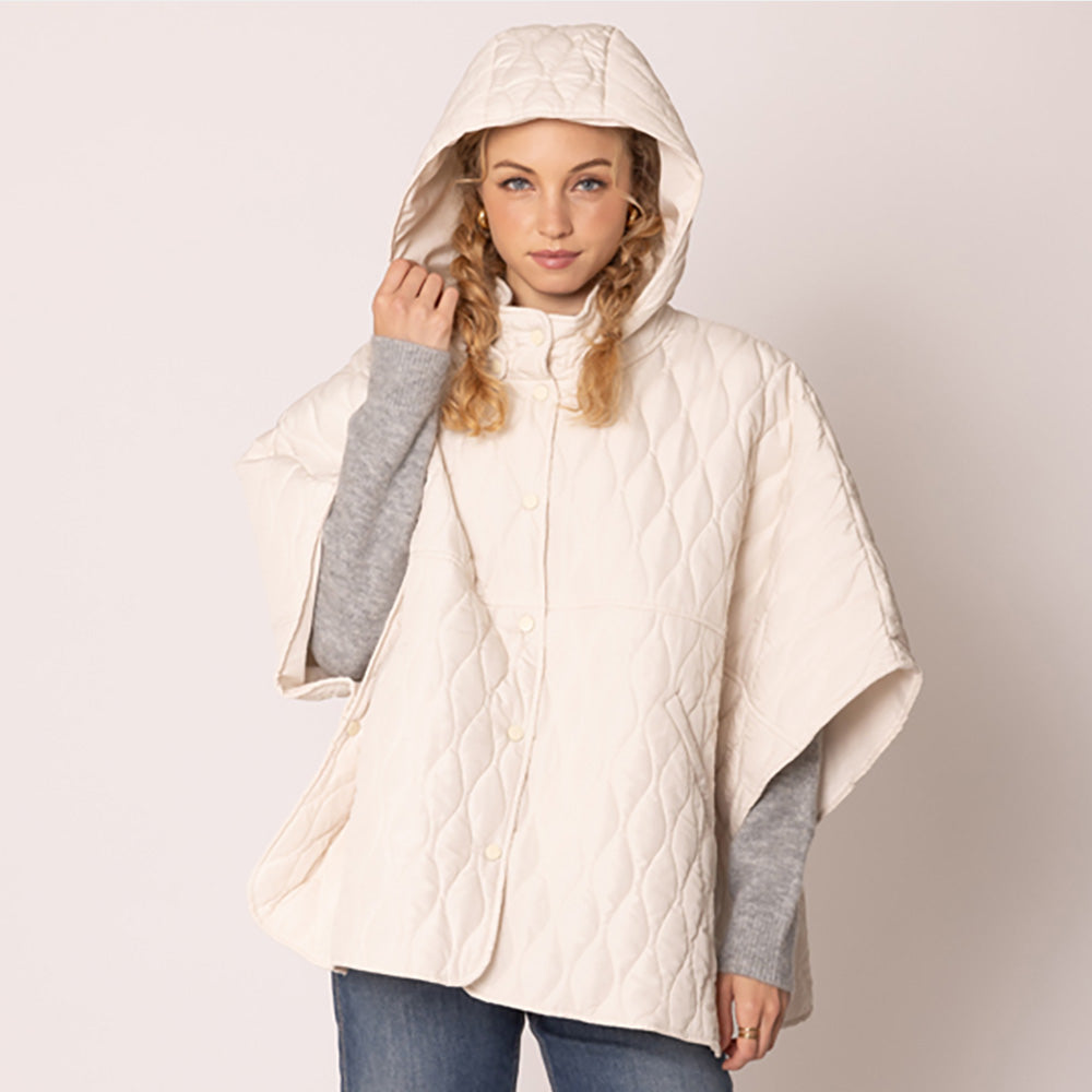 Ivory Stylish quilted cape jacket featuring a relaxed silhouette, button-up front, and attached hood for added comfort. Perfect for layering during cooler seasons, this versatile outerwear piece combines warmth with a modern, minimalistic design for effortless everyday style.