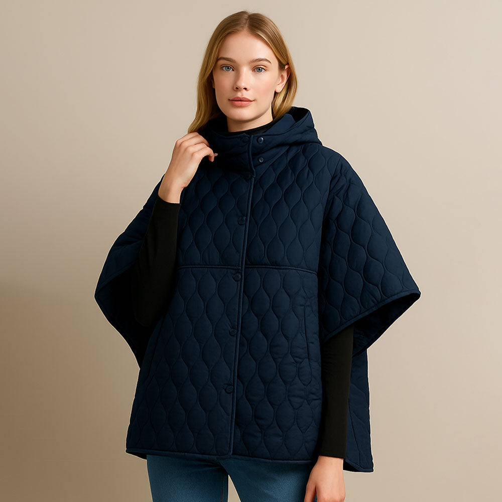 Navy Stylish quilted cape jacket featuring a relaxed silhouette, button-up front, and attached hood for added comfort. Perfect for layering during cooler seasons, this versatile outerwear piece combines warmth with a modern, minimalistic design for effortless everyday style.
