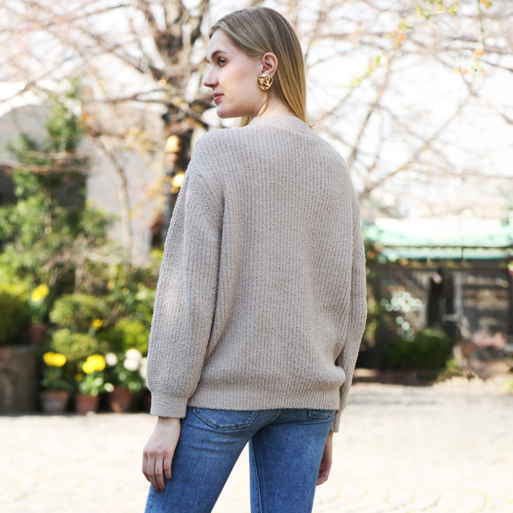 Wrap yourself in comfort with this Solid Color Ribbed Sweater, designed for effortless style and warmth. Its soft ribbed knit fabric offers a flattering fit and timeless look, perfect for pairing with jeans or skirts for any occasion.