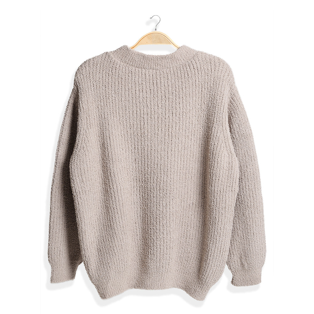 Wrap yourself in comfort with this Solid Color Ribbed Sweater, designed for effortless style and warmth. Its soft ribbed knit fabric offers a flattering fit and timeless look, perfect for pairing with jeans or skirts for any occasion.