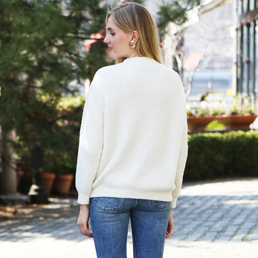 Wrap yourself in comfort with this Solid Color Ribbed Sweater, designed for effortless style and warmth. Its soft ribbed knit fabric offers a flattering fit and timeless look, perfect for pairing with jeans or skirts for any occasion.
