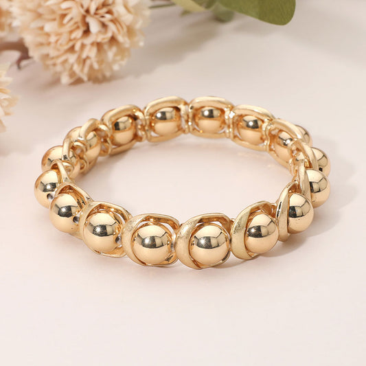 Madeline Love Gold, Worn Gold Sleek Metal Ball Beaded Stretch Bracelet