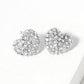 Clear Rhodium Crystal Pave Heart Stud Earrings bring a stylish and sophisticated touch to any outfit. Featuring a sparkling crystal pave design, these earrings add elegance to your look. Crafted with high-quality materials, they are perfect for any occasion. 