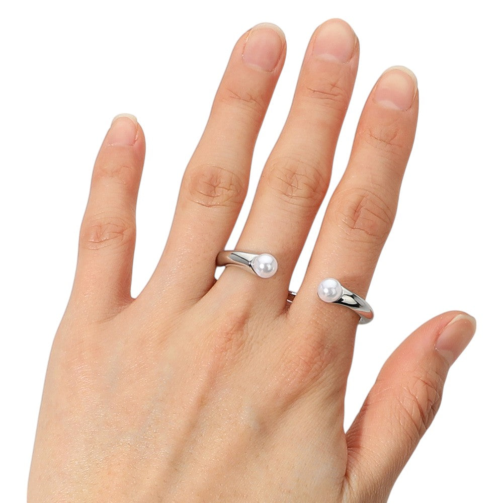 Rhodium SECRET BOX_Sterling Silver Dipped Pearl Tip Two Finger Ring is crafted with high-quality sterling silver and is finished with a delicate pearl tip. It adds a touch of elegance and sophistication to any outfit, perfect for formal occasions or everyday wear. Its unique design allows for a secure fit on two fingers, making it a versatile and stylish accessory.  