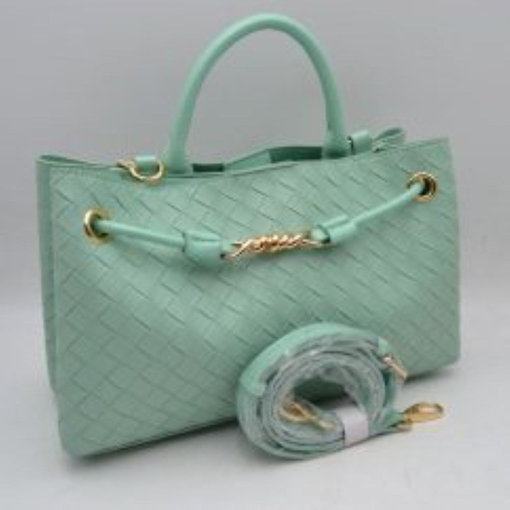 Sage Make a sophisticated statement wherever you go with this elegantly structured woven tote bag. Featuring a distinctive diagonal checkerboard weave pattern, this handbag brings a touch of modern luxury and rich texture to any wardrobe. The front is beautifully accented with a unique metallic centerpiece detail threaded through polished grommets, adding a contemporary twist to a classic silhouette. Designed for maximum versatility, it features comfortable dual top handles alongside a wrapped