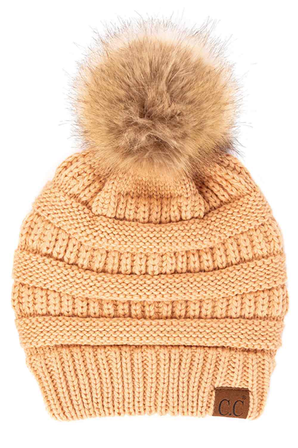 Sand Stay warm and cozy with this classic C.C Pom Pom Knit Beanie, crafted from 100% soft acrylic for all-day comfort. The ribbed knit design adds texture and durability, while the signature pom pom on top brings a playful touch to any winter outfit. One size fits most, making it the perfect accessory for everyone. Ideal for cold weather adventures or casual everyday wear.