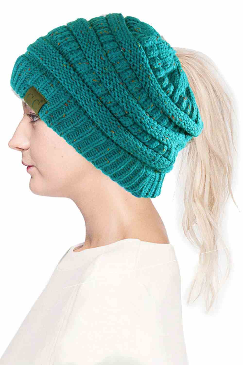 Sea Green The C.C Confetti Ponytail Messy Bun Beanie features a soft knit design with subtle confetti flecks for a fun, playful look. Designed with a convenient opening for ponytails or messy buns, it keeps you warm while allowing you to style your hair comfortably.