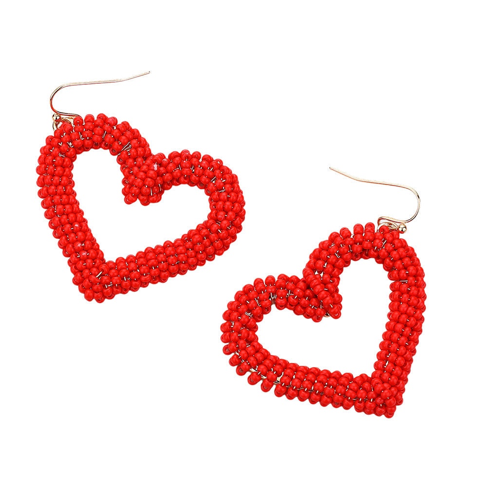 Seed Beaded Open Heart Dangle Earrings are handcrafted with delicate beads, forming an open heart that dangles elegantly. The intricate design adds a touch of romance to any outfit. These earrings are versatile and can be worn for any occasion, perfect for any fashion-forward individual. 