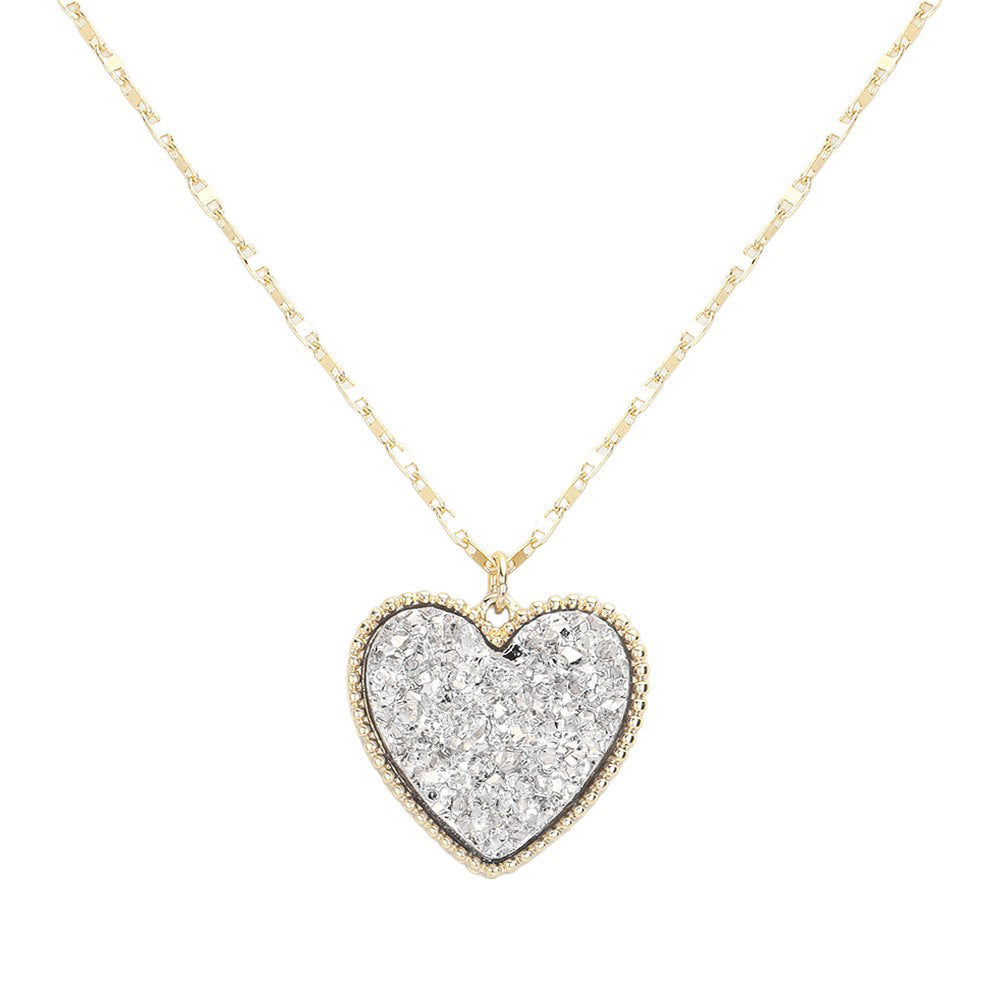 Silver Druzy Heart Pendant Necklace, this is a stunning accessory that adds a touch of sparkle to any outfit. The druzy heart pendant is beautifully crafted and catches the light for a mesmerizing effect. With its unique design and high-quality materials, this necklace is sure to make a statement and elevate your look.
