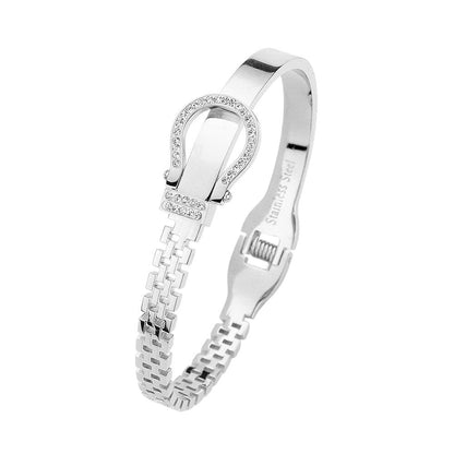 Silver Stainless steel bracelet features a stunning rhinestone belt buckle design with a hinged closure for a secure fit. Crafted with durable materials, this stylish accessory is perfect for adding a touch of elegance to any outfit. The perfect blend of fashion and function.