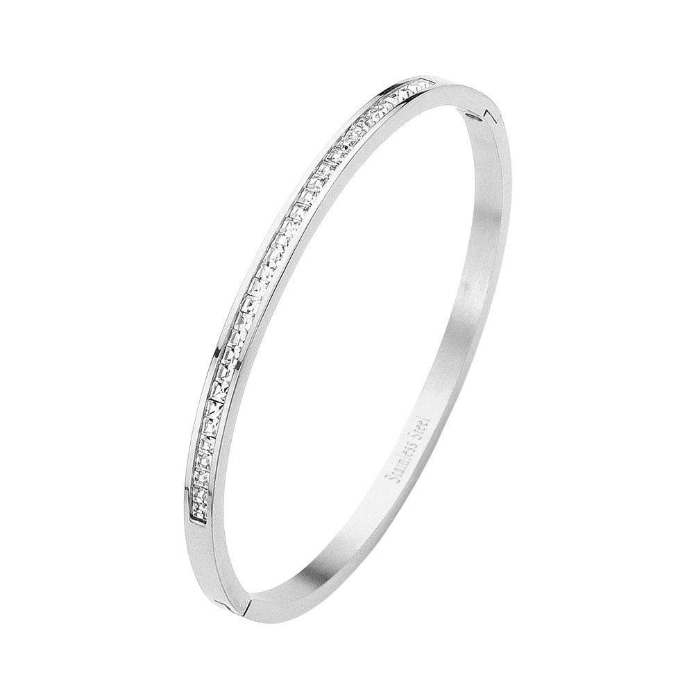 Silver Stainless Steel Rhinestone Paved Hinged Bangle Bracelet is durable and stylish for any occasion. Featuring a sleek stainless steel design and sparkling rhinestone accents, this hinged bangle is perfect for adding a touch of elegance to any outfit. With its sturdy construction and eye-catching design, this bracelet is a must-have for any fashion-forward individual.
