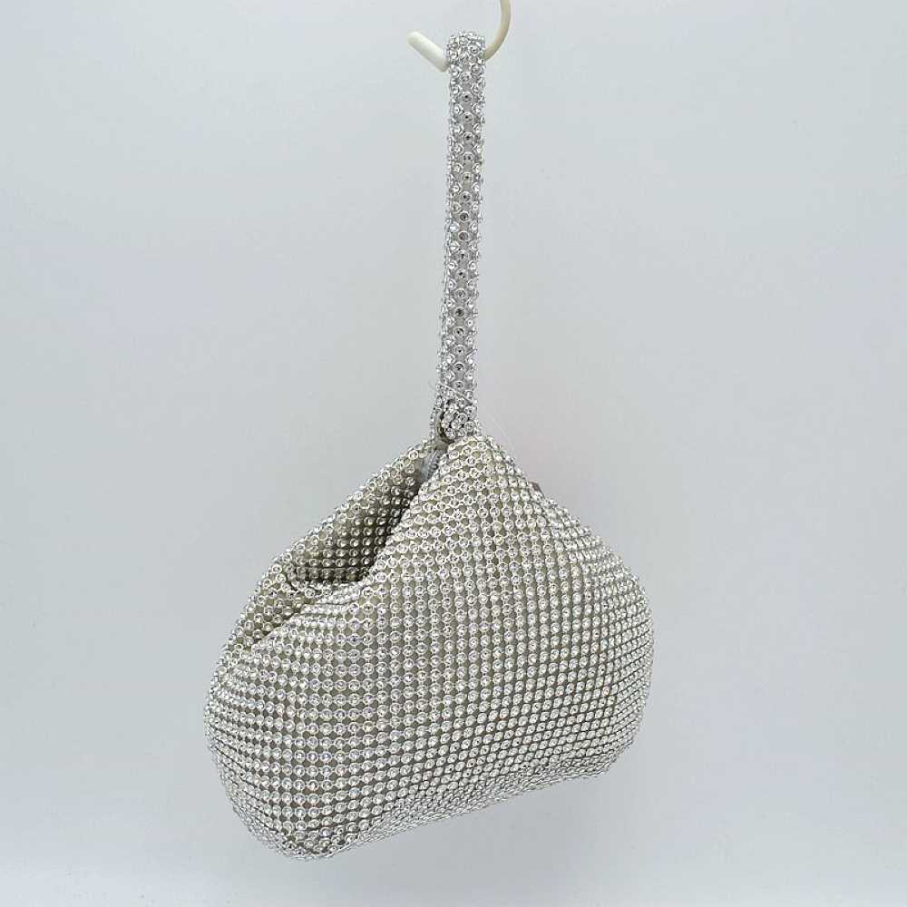 Silver Make a bold yet elegant statement with the shimmering evening pouch. Perfect for nights out, formal dinners, or special events, this unique wristlet infuses any outfit with instant texture and subtle sparkle.