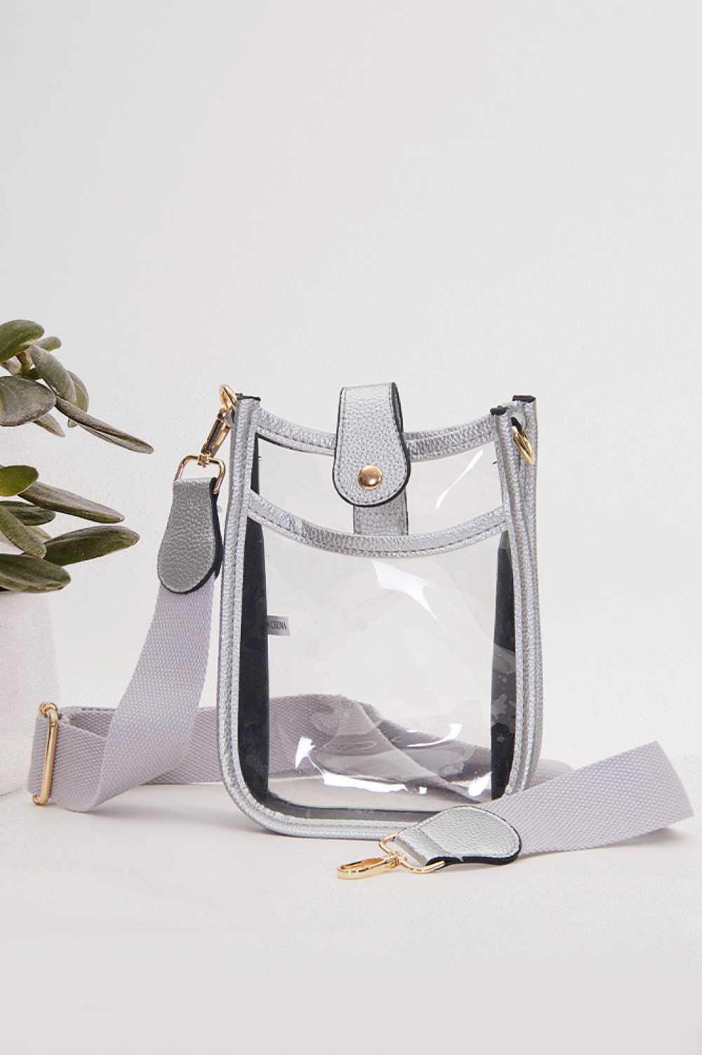 Silver Perfect for concert season and stadium events, this clear crossbody mini bag meets all venue security requirements while keeping your essentials within reach. Crafted from durable 100% PVC, it's easy to clean and built to last through countless outings. Compact yet functional at 8" x 5.8" x 2.3", the adjustable crossbody strap sits comfortably across your body, leaving your hands free. The transparent design lets you quickly locate your phone, keys, and small valuables at a glance.