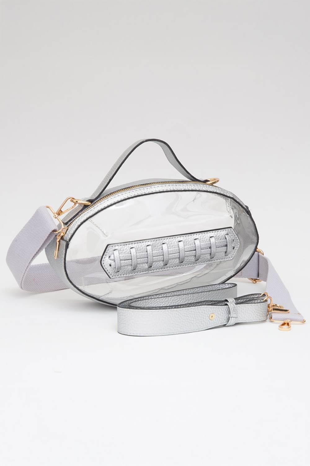 Silver Carry your essentials in style with this unique football-shaped transparent crossbody bag. Perfect for stadium events, concerts, and outdoor gatherings, the clear PVC design lets you see everything inside while meeting venue security requirements. Measuring 11" x 6" x 4", it offers practical storage without bulk. The adjustable crossbody strap keeps your hands free, making it ideal for busy days out. Durable 100% PVC construction ensures long-lasting wear through countless adventures.