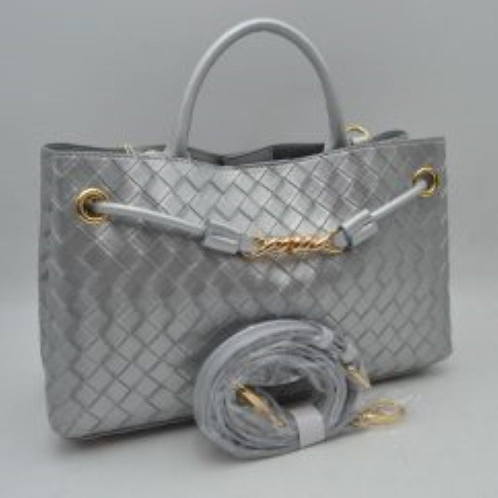 Silver Make a sophisticated statement wherever you go with this elegantly structured woven tote bag. Featuring a distinctive diagonal checkerboard weave pattern, this handbag brings a touch of modern luxury and rich texture to any wardrobe. The front is beautifully accented with a unique metallic centerpiece detail threaded through polished grommets, adding a contemporary twist to a classic silhouette. Designed for maximum versatility, it features comfortable dual top handles alongside a wrapped