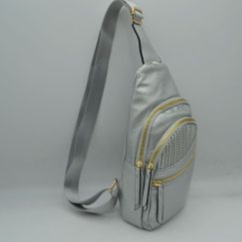 Silver This versatile sling bag features an asymmetric silhouette decorated with an arched, perforated pattern on the front panel, making it suitable for everyday use. It offers multiple organized storage compartments, including a main curved section, a mid-sized front zippered pouch, and a smaller diagonal zippered pocket near the base, all equipped with elongated pull tabs. Designed for convenience, the bag is completed with a single wide