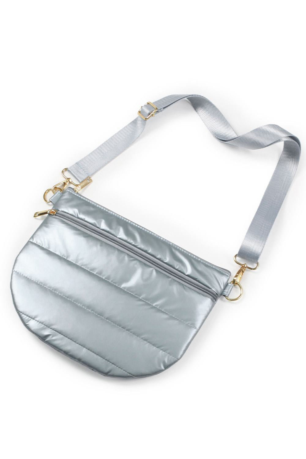 Silver The Puffy Half Moon Bag brings playful style to your everyday carry. Its distinctive half-moon silhouette offers a modern twist on classic bag design, while the soft, puffy construction adds dimension and visual interest. Crafted from durable 100% polyester, this bag is built to withstand daily use while maintaining its shape. The compact 11.5" x 8" size fits essentials perfectly ideal for quick outings, travel, or as a statement accessory.