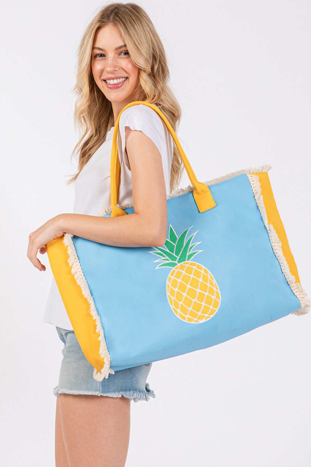 Sky Blue Brighten your summer style with this vibrant tote bag, featuring charming embroidered patches of anchors, pineapples, and flamingos. The playful fringe detailing adds a fun, beachy vibe perfect for beach days, shopping, or casual outings. Crafted from durable 100% polyester, this spacious tote measures 17.5" x 14" x 5", offering plenty of room for all your essentials. The convenient magnetic closure keeps your belongings secure, while the inner pocket provides smart organization for smaller items. 