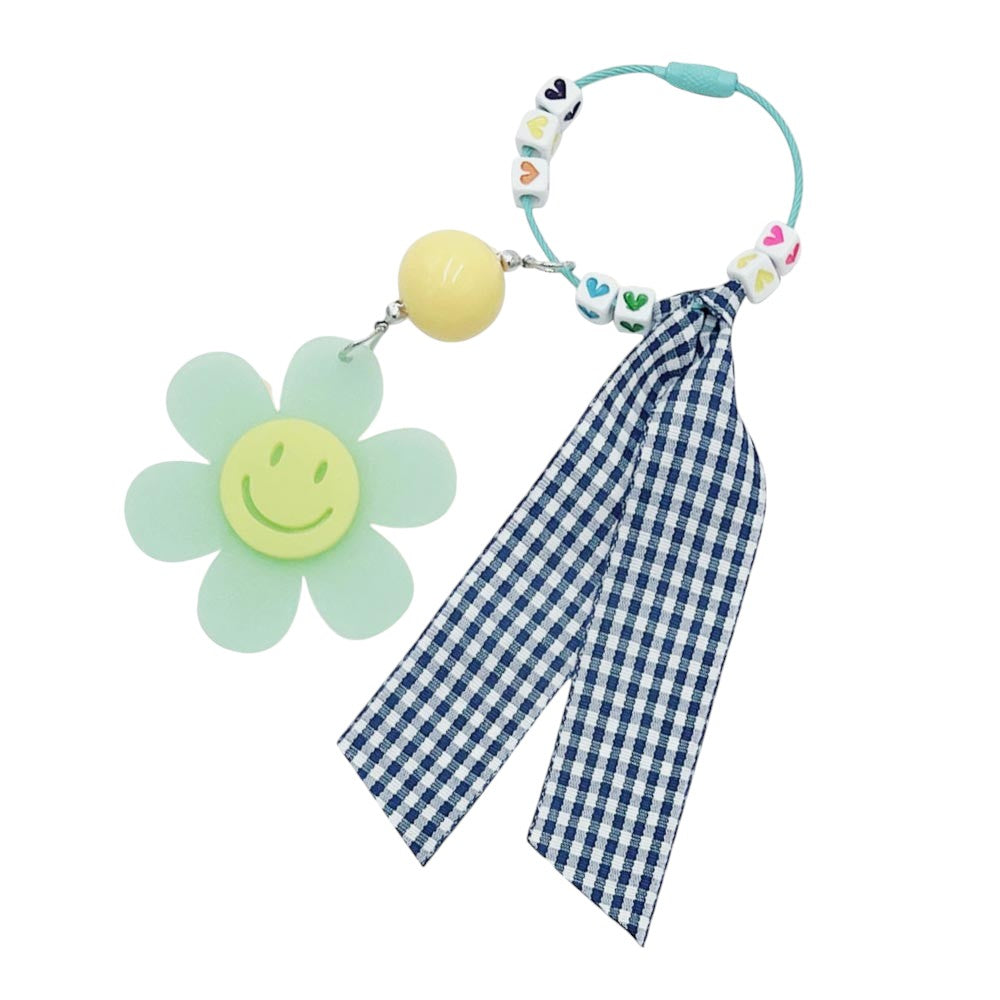 Mint Smile Flower Heart Gingham Ribbon Bag Charm / Keychain features a delicate gingham ribbon and a smile flower heart design. Add a touch of whimsy to your bag or keys with this delightful accessory. Made with high-quality materials, this charm is a perfect addition to any fashion-forward individual's collection. 