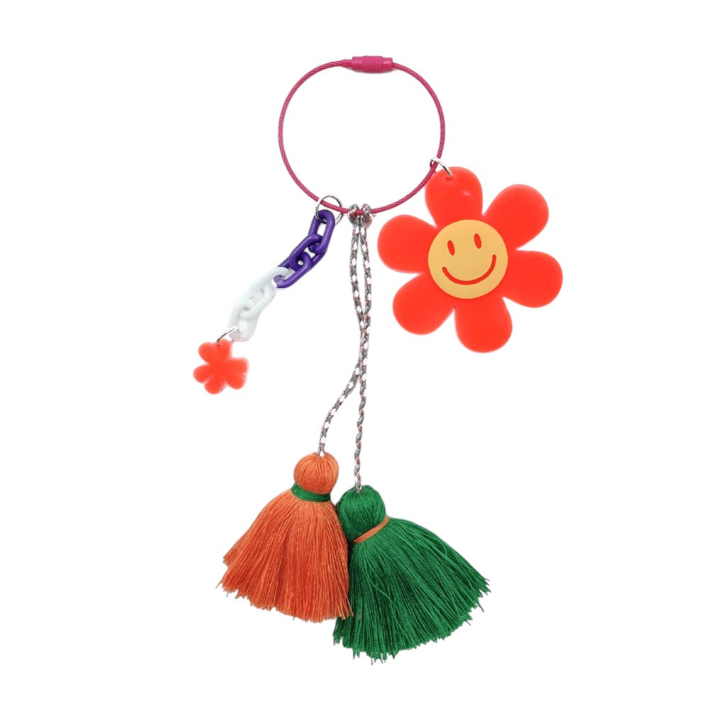 orange Smile Flower Tassel Bag Charm / Keychain is a whimsical and versatile accessory that will add a touch of fun to any bag or keychain. The charming design features a vibrant smile flower, adding a pop of color to your everyday look. Made with high-quality materials, this keychain is both durable and stylish. 